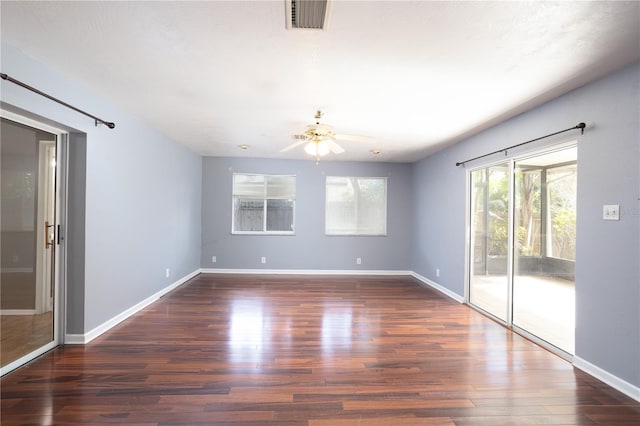 spare room featuring dark hardwood / wood-style floors and ceiling fan