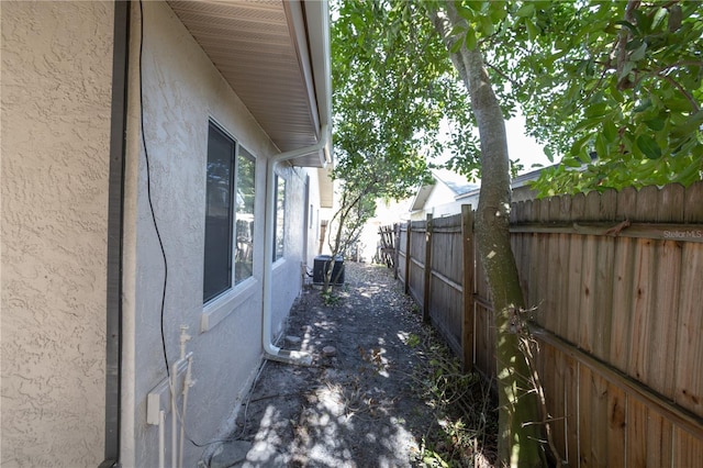 view of side of home featuring central AC unit