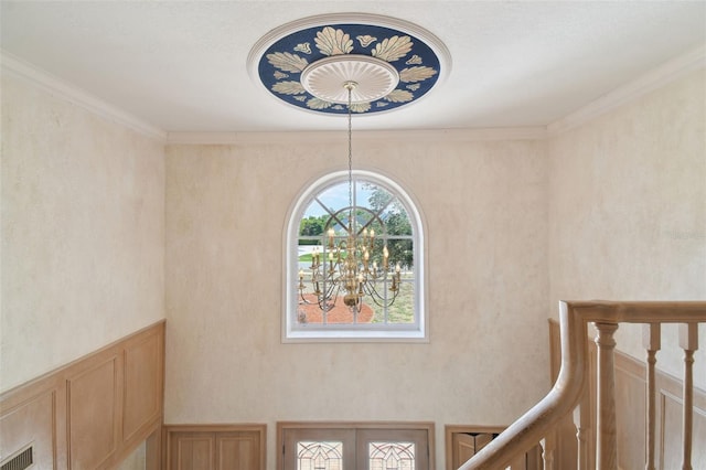 interior space featuring an inviting chandelier and crown molding