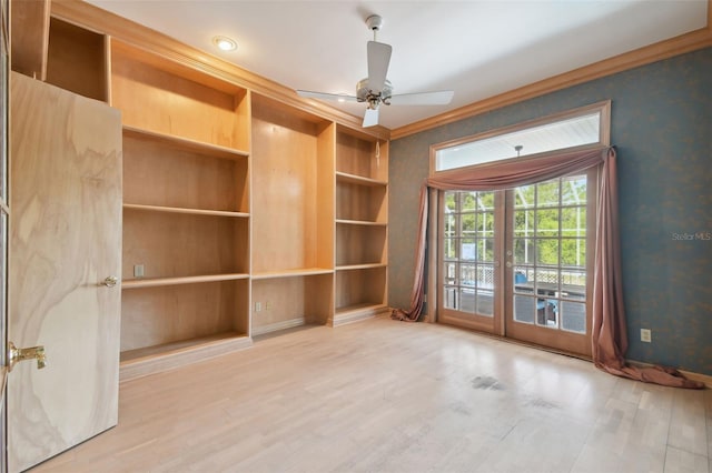 empty room featuring hardwood / wood-style floors, built in features, and ceiling fan