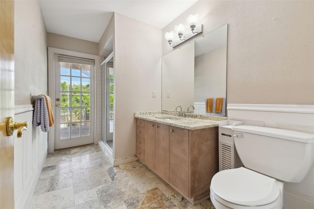 bathroom with tile floors, walk in shower, toilet, and vanity