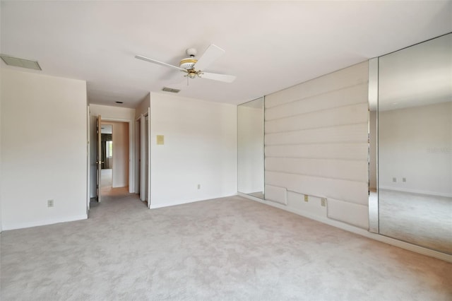 unfurnished room featuring ceiling fan and carpet floors