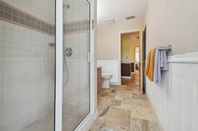 bathroom with a shower with shower door, tile flooring, and toilet