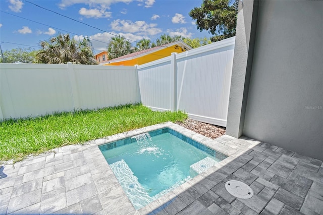 view of swimming pool featuring pool water feature and a patio