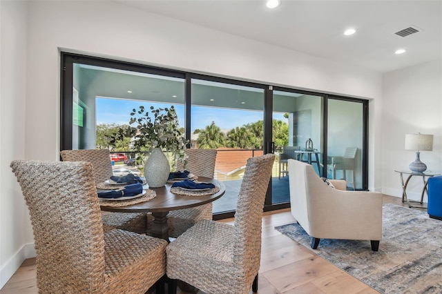 dining space featuring a wealth of natural light and light hardwood / wood-style flooring