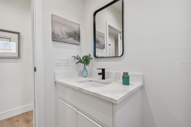 bathroom with hardwood / wood-style floors and vanity