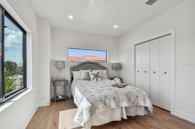 bedroom featuring light hardwood / wood-style floors and a closet