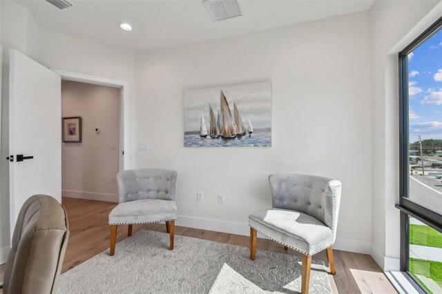 sitting room with a healthy amount of sunlight and light hardwood / wood-style floors