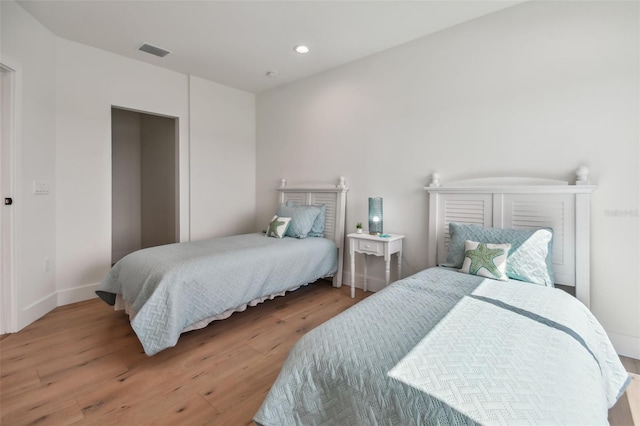 bedroom with hardwood / wood-style floors