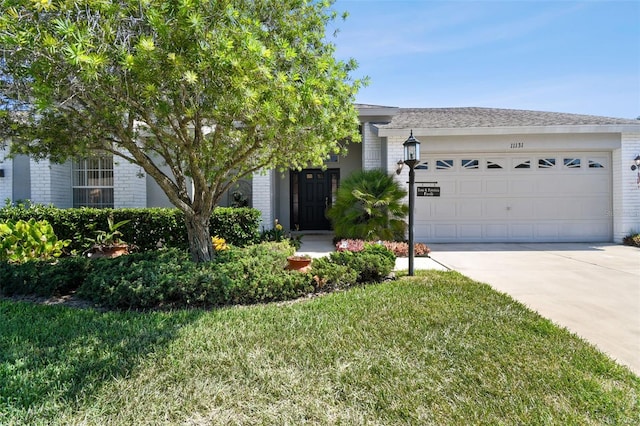 view of front facade featuring a front lawn and a garage