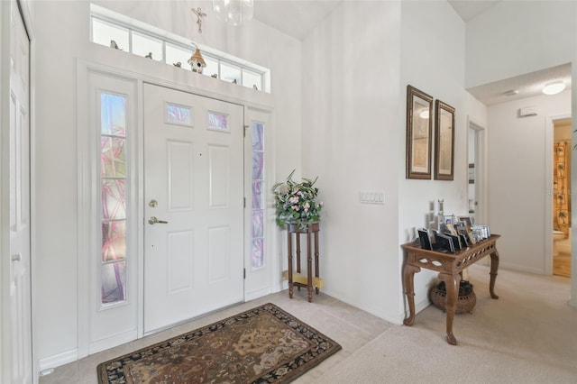 view of carpeted foyer entrance