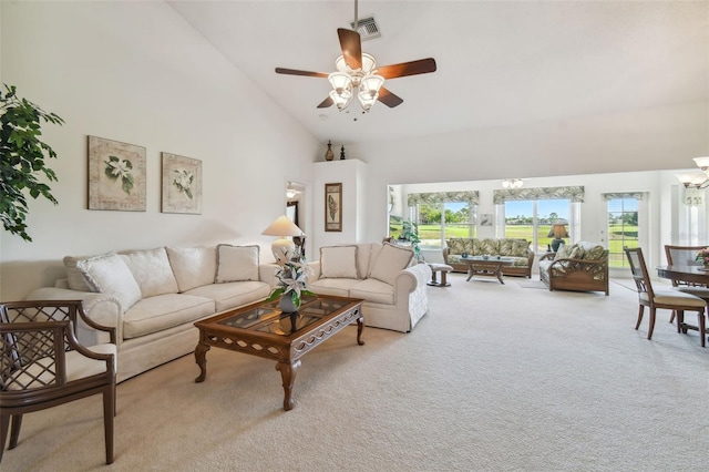 carpeted living room featuring ceiling fan and high vaulted ceiling