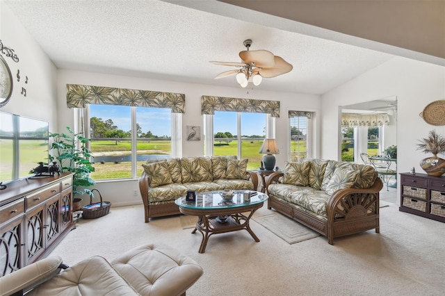 living room featuring light carpet, a textured ceiling, vaulted ceiling, and ceiling fan