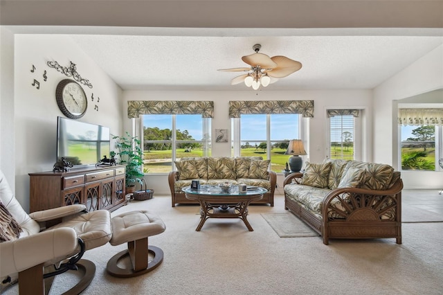 living room featuring carpet floors, a wealth of natural light, and ceiling fan