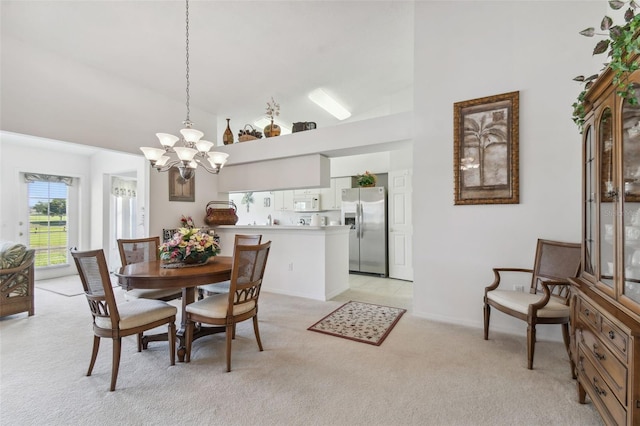 carpeted dining room with high vaulted ceiling and a notable chandelier