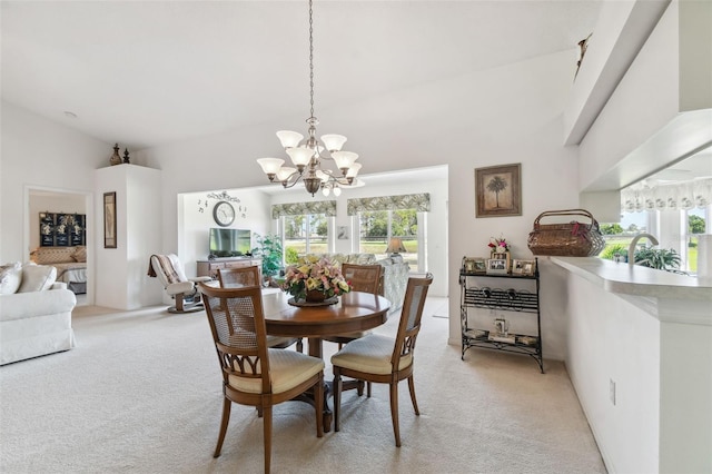 carpeted dining area with an inviting chandelier