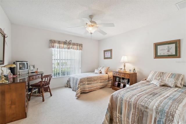 bedroom with carpet flooring, a textured ceiling, and ceiling fan