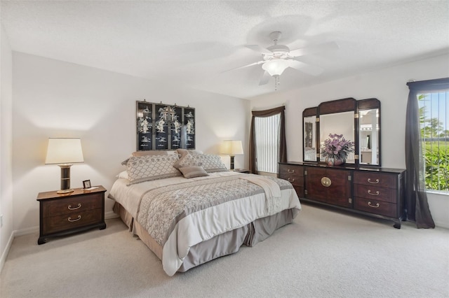 carpeted bedroom with a textured ceiling and ceiling fan