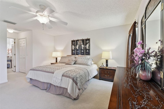 bedroom with carpet flooring, ceiling fan, a closet, and a textured ceiling