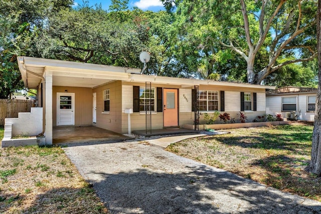 ranch-style house with a carport and a front lawn