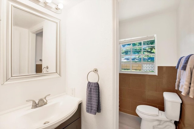 6490 34th Ave N, Saint Petersburg, FL 33710 - bathroom featuring tile walls, vanity, and toilet
