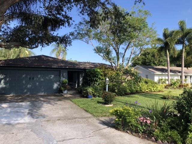 ranch-style house with a front lawn and a garage