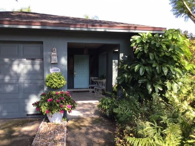 view of exterior entry with a garage