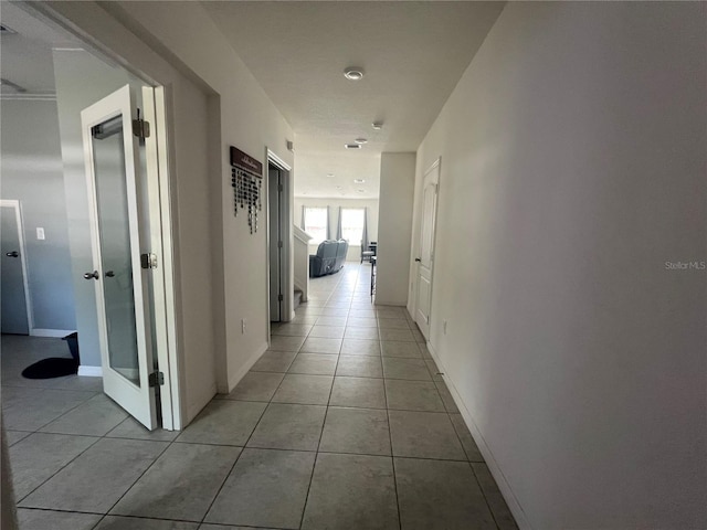 hallway with light tile patterned flooring