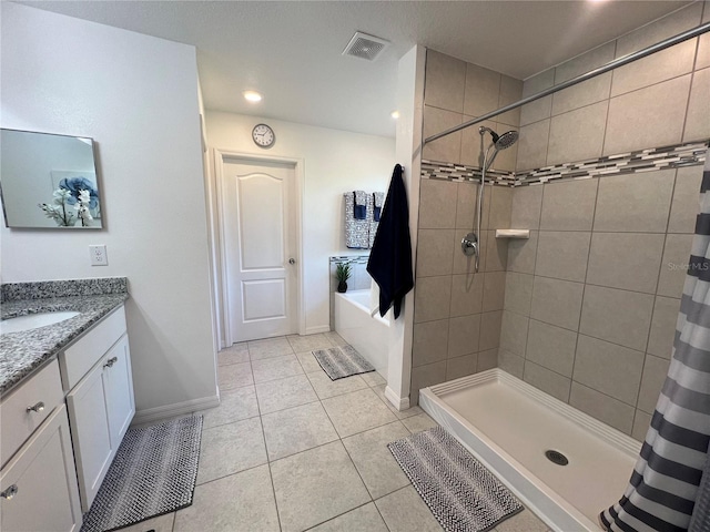 bathroom featuring tile patterned floors, vanity, and walk in shower