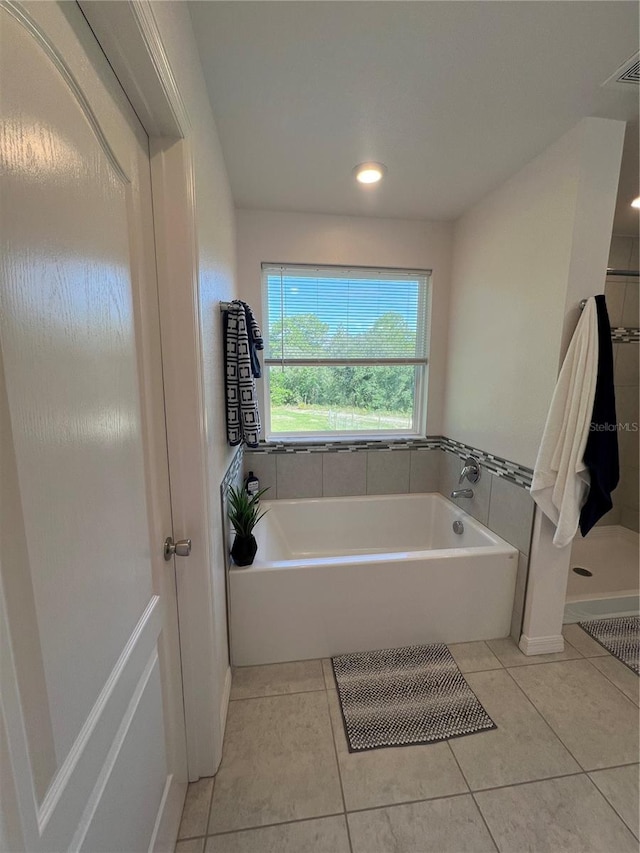 bathroom featuring tile patterned flooring and plus walk in shower