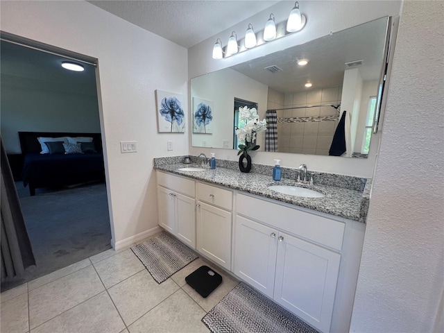 bathroom featuring vanity, a textured ceiling, curtained shower, and tile patterned flooring