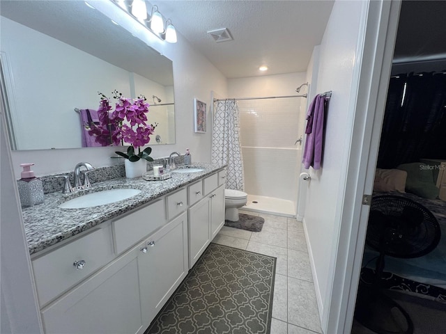 bathroom with vanity, a shower with curtain, tile patterned flooring, toilet, and a textured ceiling