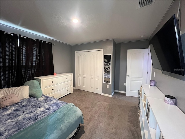 carpeted bedroom featuring a textured ceiling and a closet