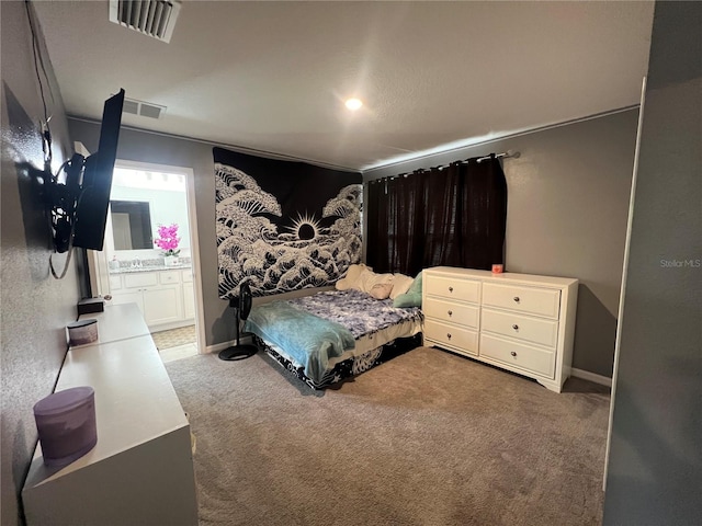 carpeted bedroom featuring connected bathroom