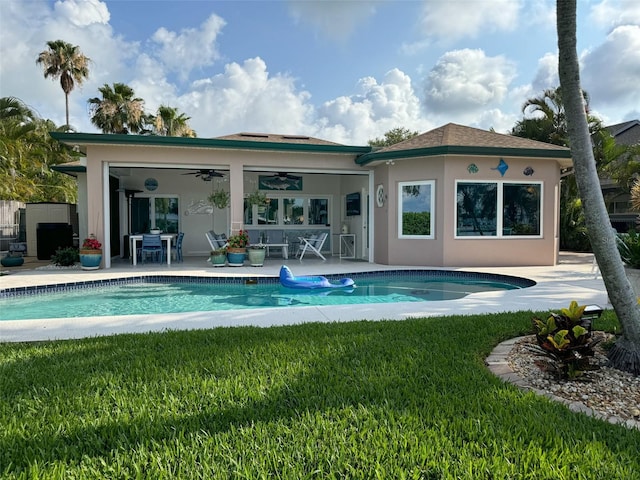 rear view of house with a yard, a patio, and ceiling fan