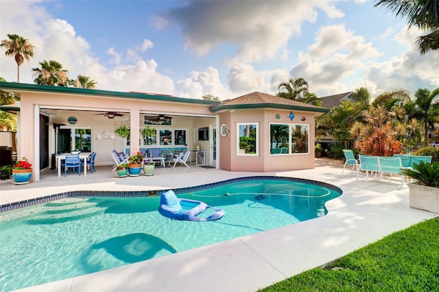 view of pool with an outbuilding, ceiling fan, and a patio area