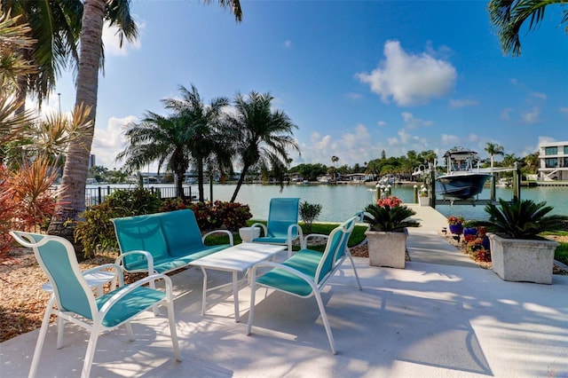 view of patio with a dock and a water view