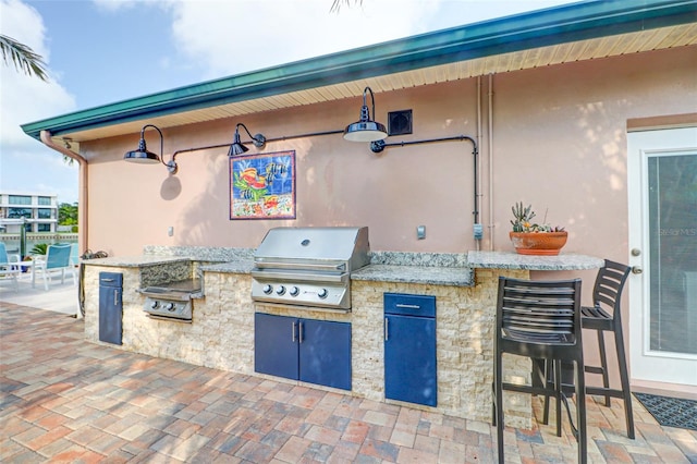 view of patio / terrace with a bar and area for grilling