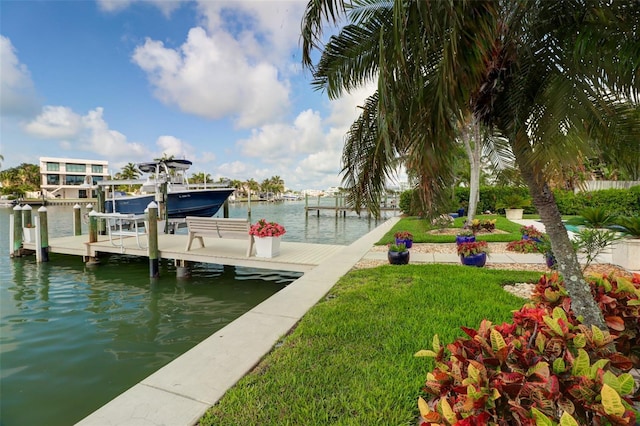 dock area featuring a water view and a lawn