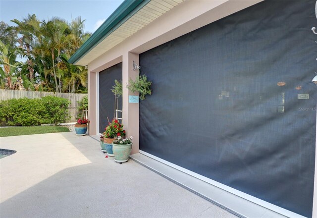 view of exterior entry with a patio area