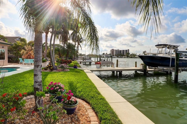 dock area featuring a water view and a lawn