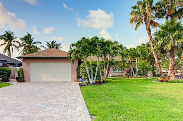 view of front of property with a garage and a front lawn