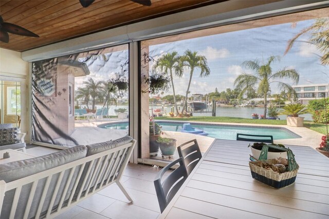 exterior space featuring ceiling fan and wood ceiling