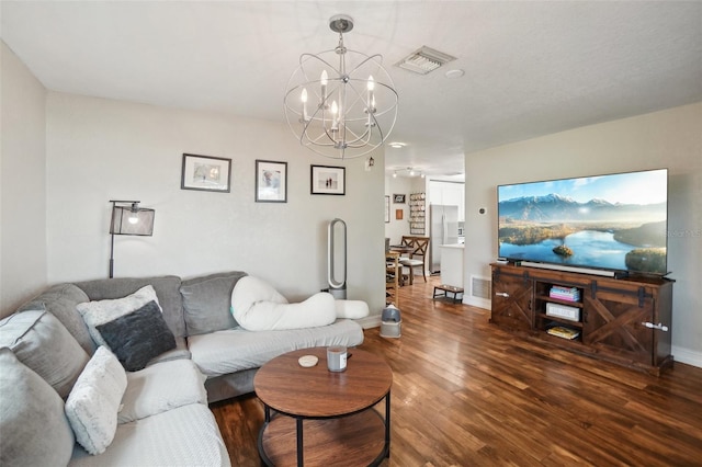 living room featuring dark wood-type flooring and a chandelier