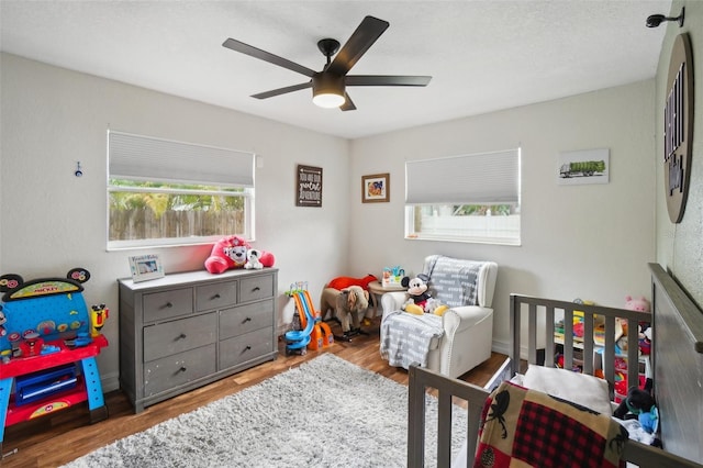 bedroom with ceiling fan and light hardwood / wood-style floors