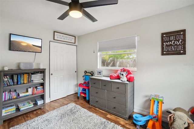 recreation room featuring dark hardwood / wood-style floors and ceiling fan