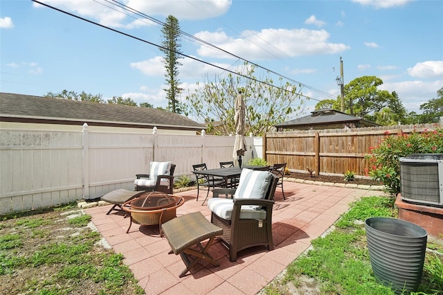 view of patio featuring an outdoor fire pit and central AC unit