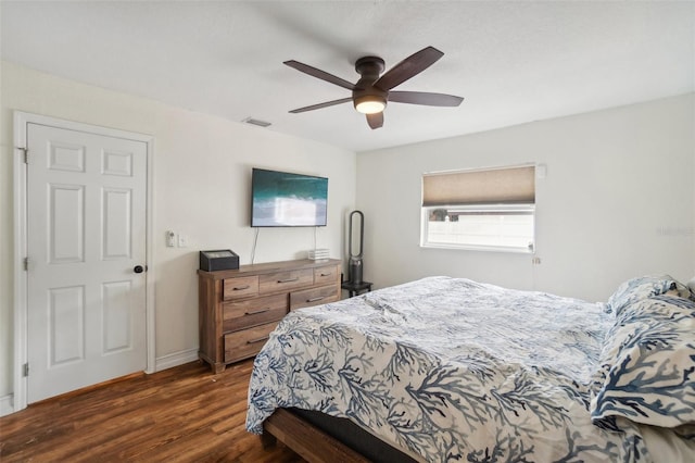 bedroom with dark hardwood / wood-style floors and ceiling fan