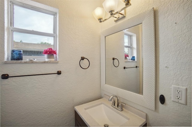 bathroom featuring vanity and a chandelier