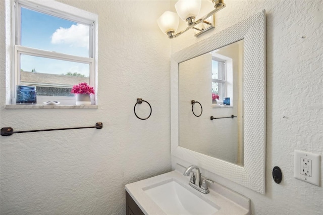 bathroom featuring vanity and a chandelier